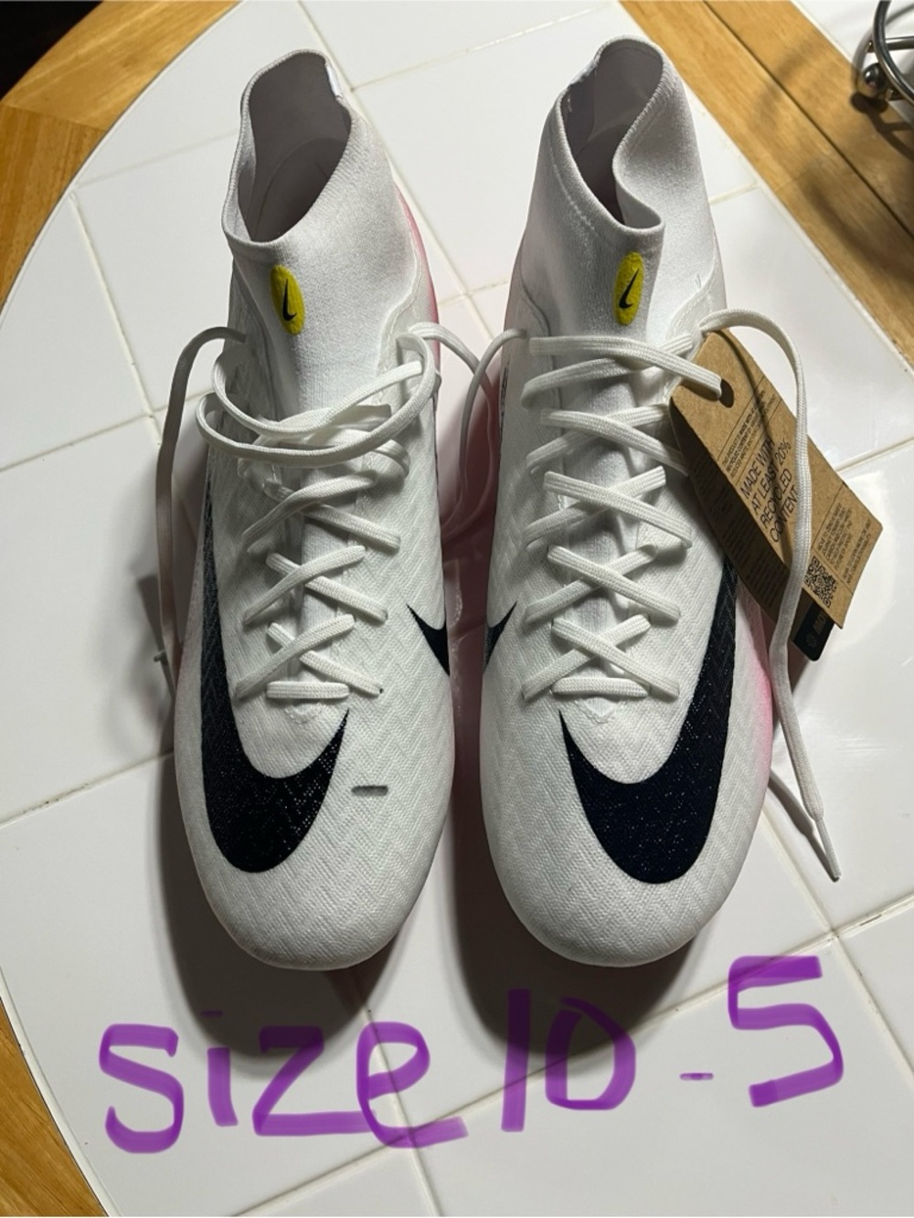 Nike White High-Top Soccer Cleats with Black Swoosh and Pink Accents